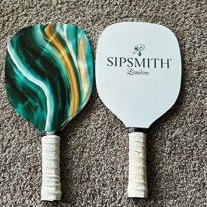 Two wooden pickle ball paddles